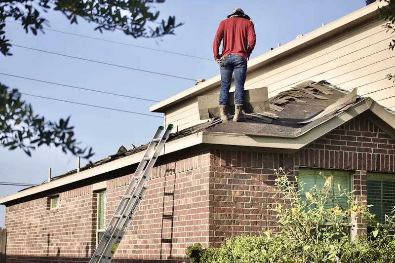 Professional roofer working on a residential roof in Excelsior Springs